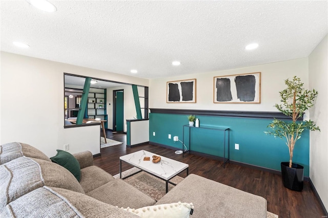 living room featuring a textured ceiling and dark hardwood / wood-style floors