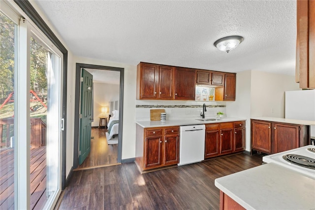 kitchen featuring backsplash, dark hardwood / wood-style floors, sink, and white appliances