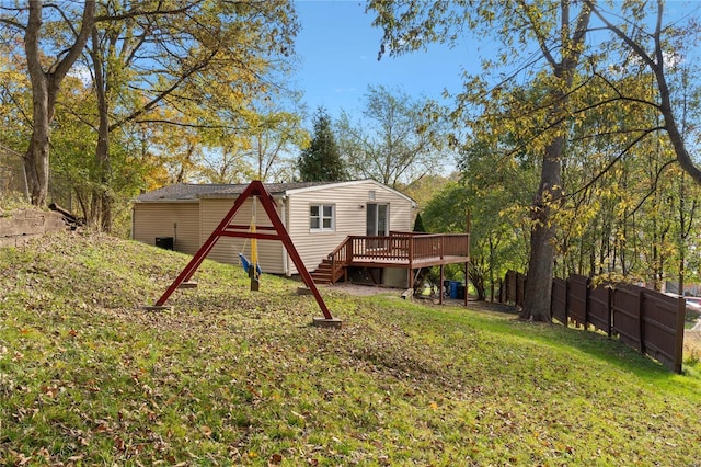 back of property featuring a lawn and a deck