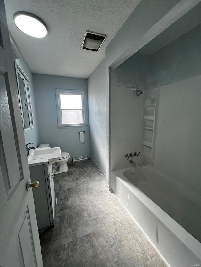 full bathroom with vanity, a textured ceiling, washtub / shower combination, and toilet