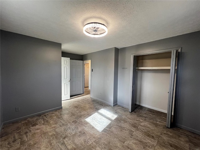 unfurnished bedroom with a closet and a textured ceiling