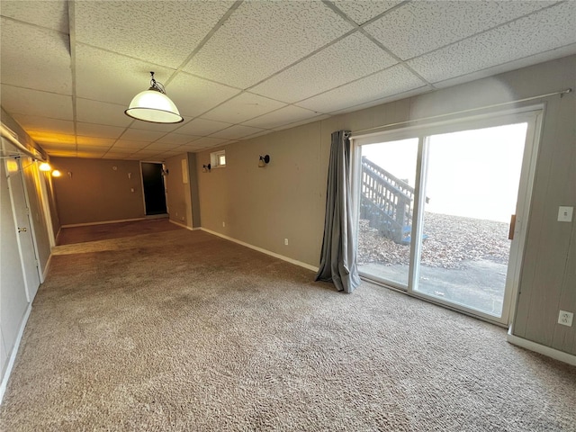 unfurnished room with a paneled ceiling and carpet floors