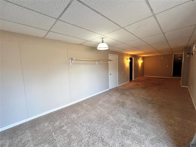 basement with carpet flooring and a drop ceiling