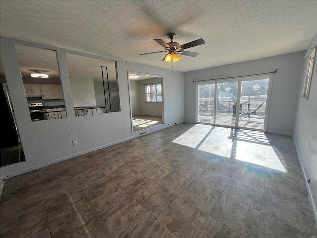 unfurnished room featuring ceiling fan and a textured ceiling