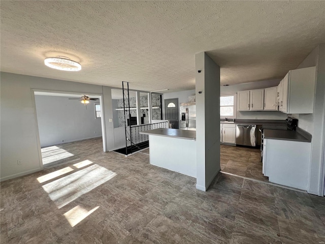 kitchen featuring sink, ceiling fan, appliances with stainless steel finishes, white cabinets, and kitchen peninsula