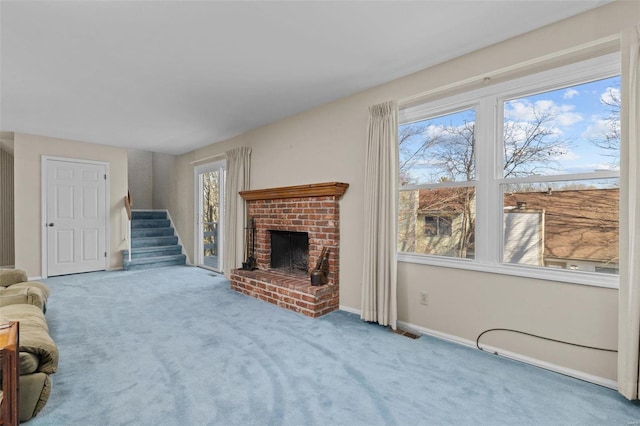 carpeted living room with plenty of natural light and a brick fireplace