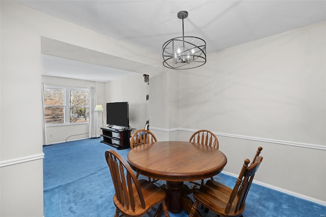 carpeted dining area with a chandelier