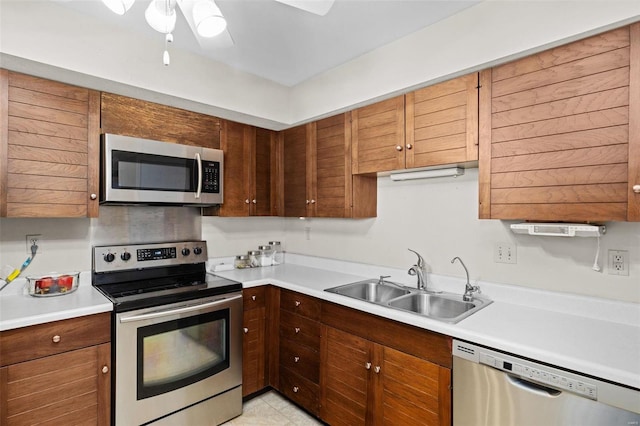 kitchen with ceiling fan, stainless steel appliances, and sink