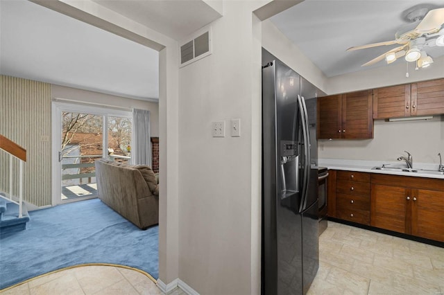 kitchen with fridge with ice dispenser, sink, light colored carpet, and ceiling fan