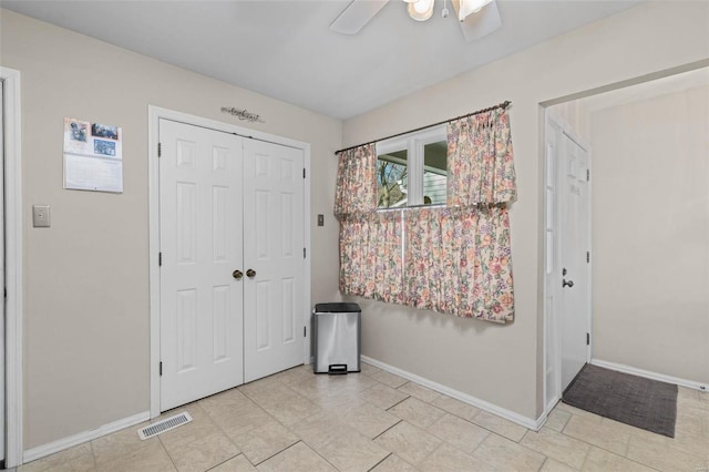 foyer featuring ceiling fan