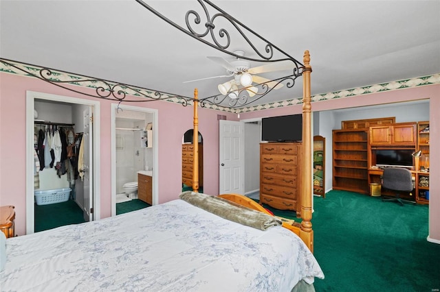 bedroom featuring dark carpet, a walk in closet, ensuite bath, and a closet