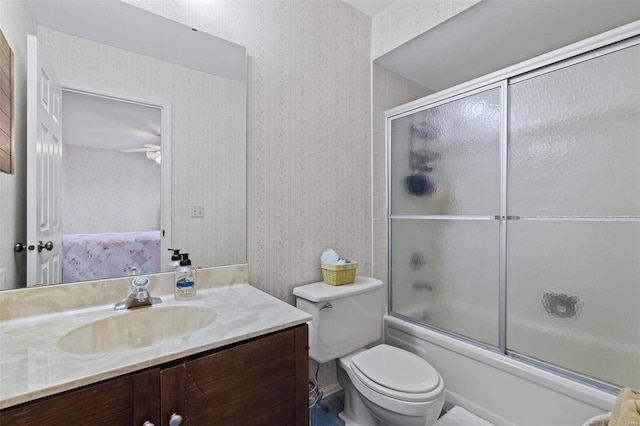 full bathroom with vanity, shower / bath combination with glass door, and toilet