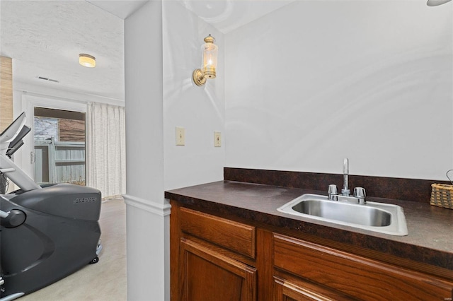 kitchen featuring sink and a textured ceiling