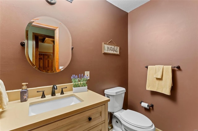 bathroom featuring toilet and vanity