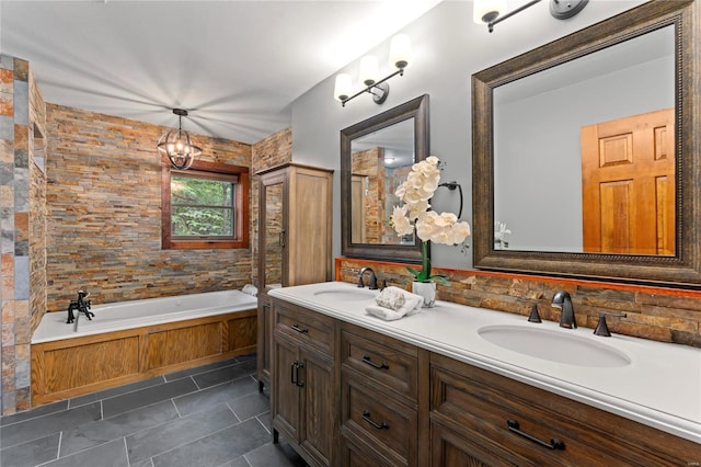 bathroom with tile patterned flooring, a tub to relax in, and vanity