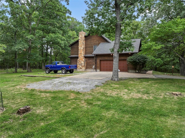 exterior space featuring a lawn and a garage