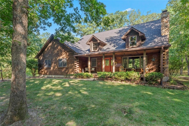 log home with covered porch and a front lawn