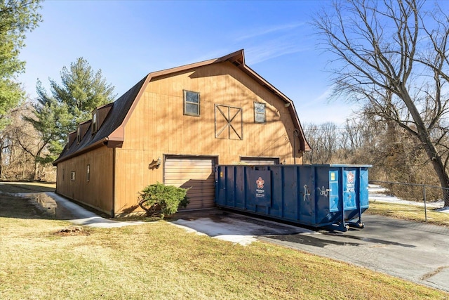 view of side of property featuring a yard and an outdoor structure