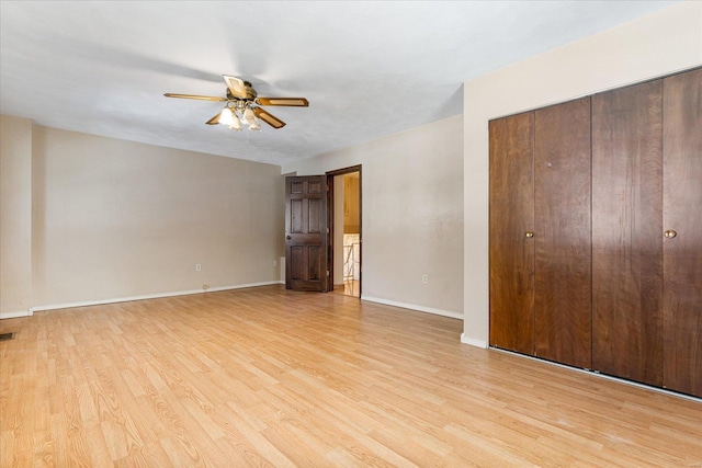 unfurnished bedroom featuring light hardwood / wood-style flooring, a closet, and ceiling fan