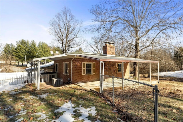 view of side of home featuring cooling unit