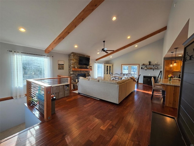 living room featuring ceiling fan, beam ceiling, high vaulted ceiling, a fireplace, and dark hardwood / wood-style flooring