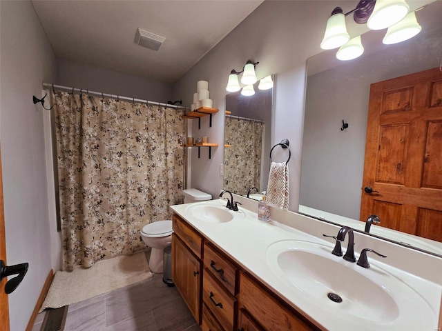 bathroom with vanity, toilet, and walk in shower