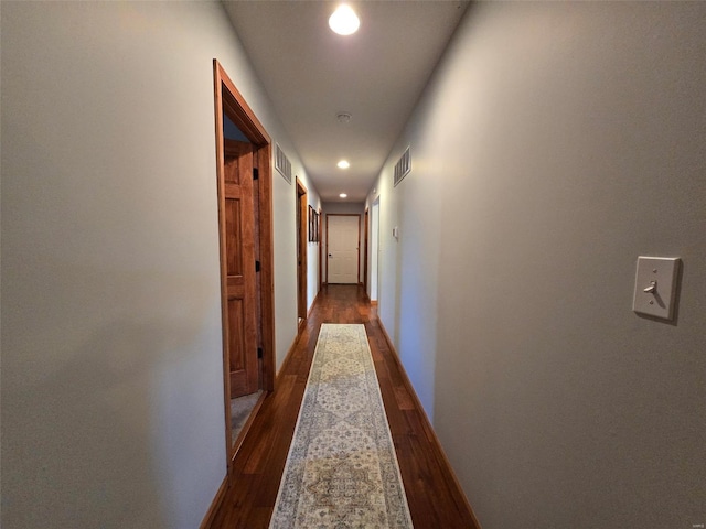 hallway with dark wood-type flooring