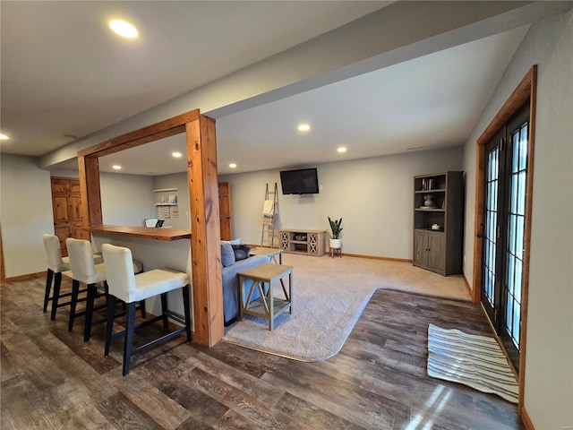 interior space featuring wood-type flooring and bar