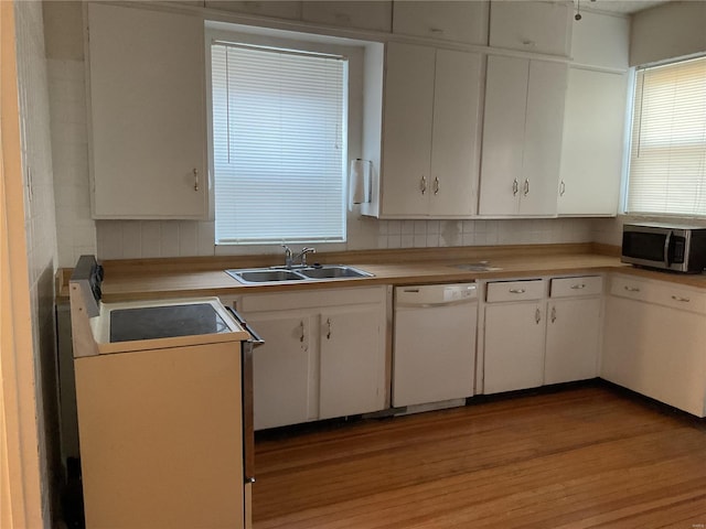 kitchen with sink, light hardwood / wood-style flooring, dishwasher, white cabinetry, and electric range oven