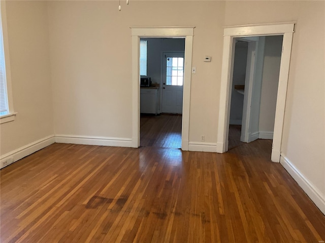 empty room with dark wood-type flooring