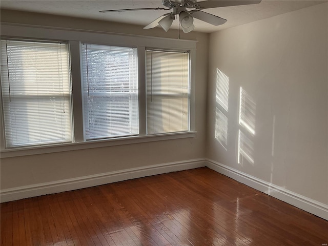 empty room with hardwood / wood-style flooring, a wealth of natural light, and ceiling fan