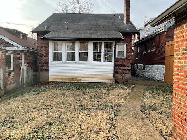 back of house featuring a yard