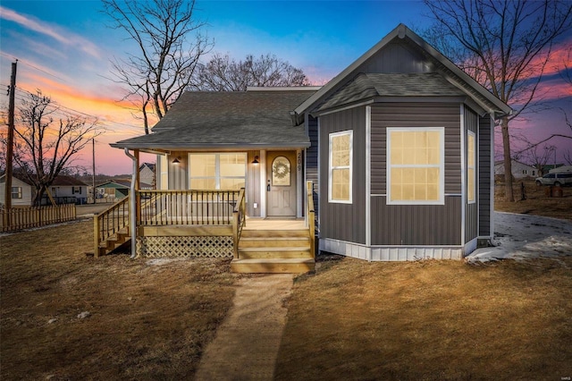 view of front of property featuring a yard and a porch