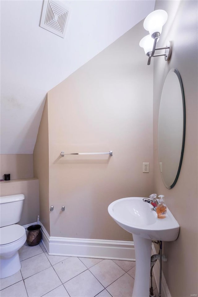 bathroom featuring tile patterned floors, toilet, and lofted ceiling