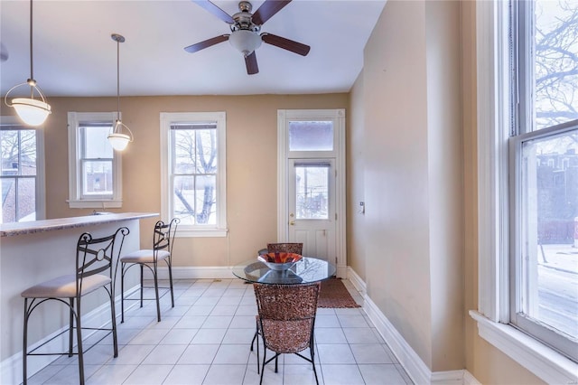 tiled dining room featuring ceiling fan