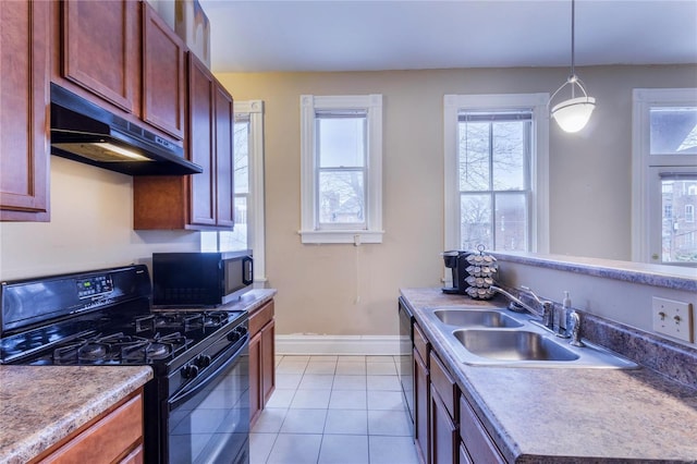 kitchen featuring black gas range, light tile patterned floors, decorative light fixtures, and sink