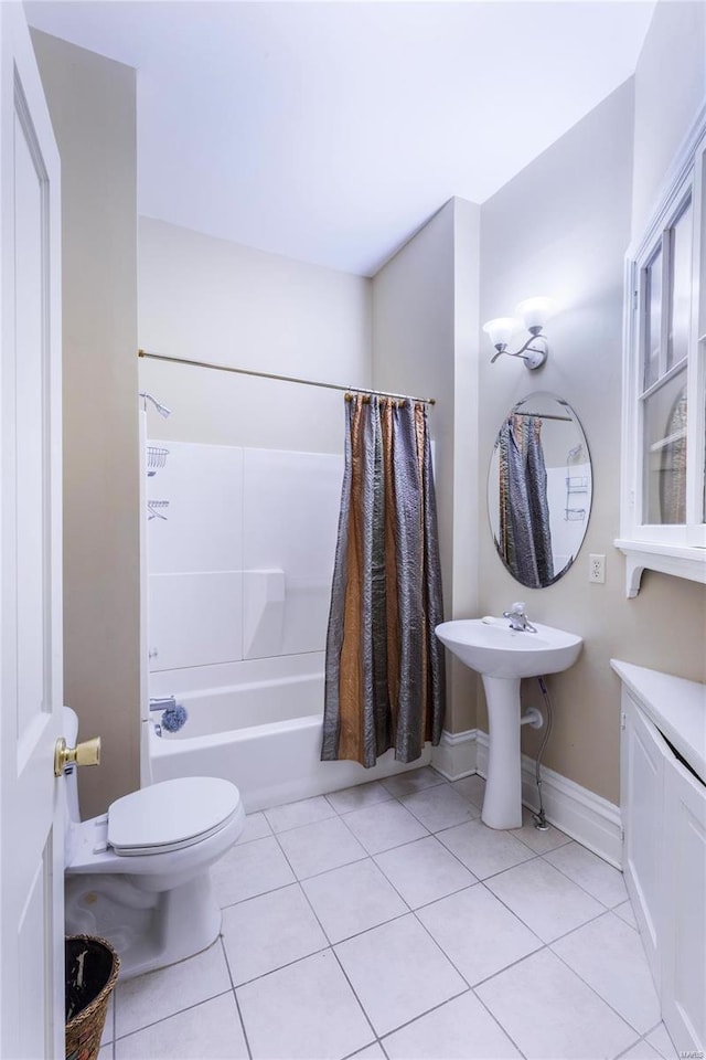 bathroom with toilet, tile patterned floors, and shower / tub combo with curtain