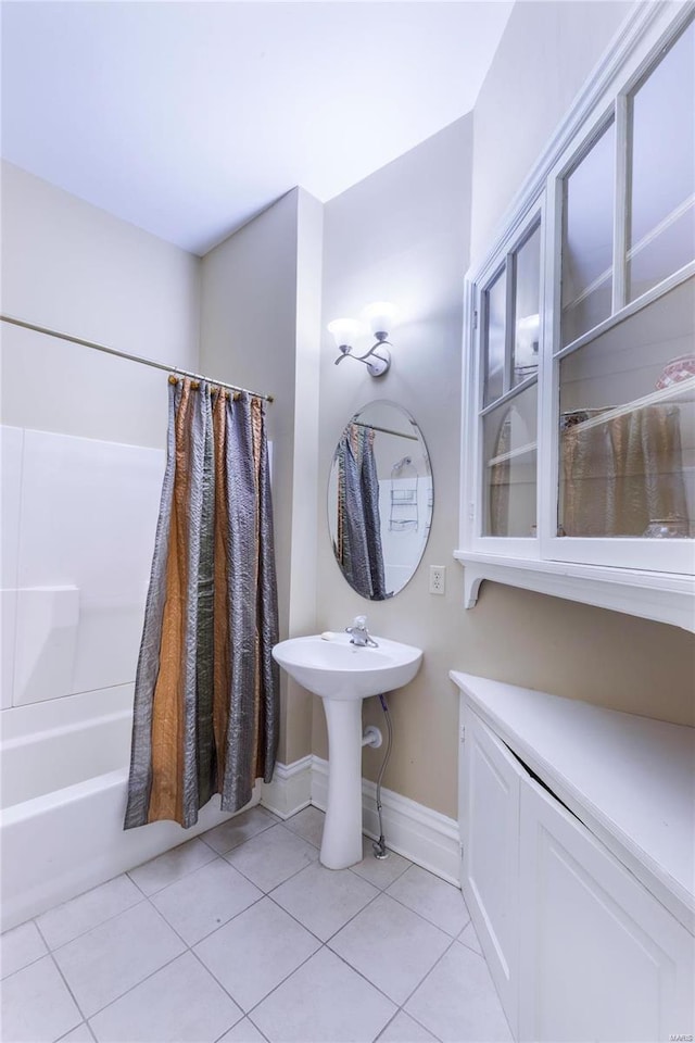 bathroom featuring tile patterned floors and shower / bath combo with shower curtain