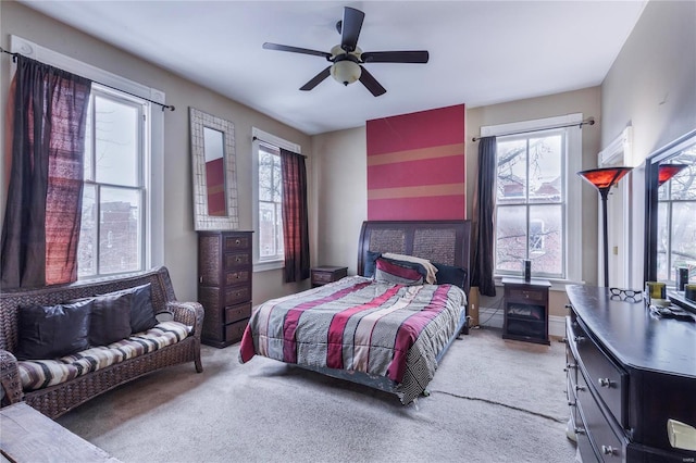 bedroom with ceiling fan, carpet, and multiple windows