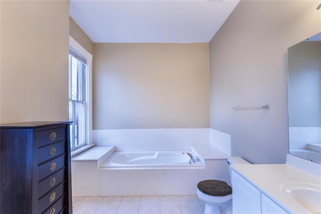 bathroom featuring toilet, vanity, tile patterned floors, and a relaxing tiled tub