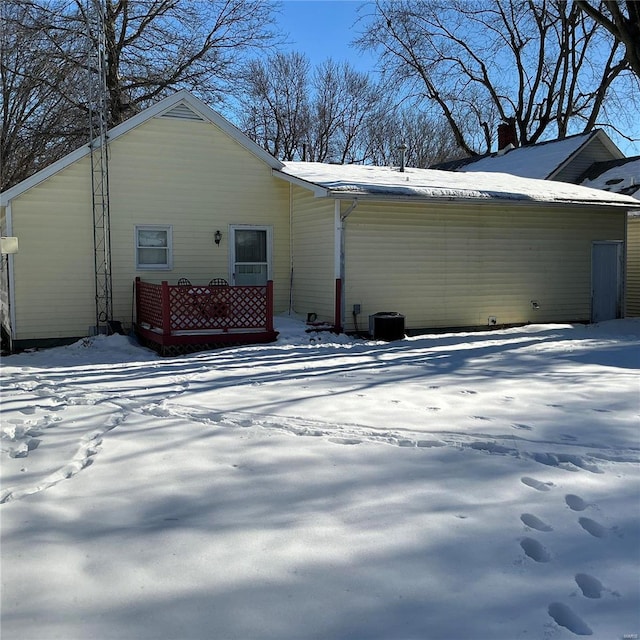 view of snow covered rear of property