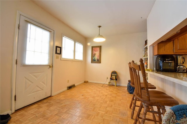 dining area featuring light parquet floors