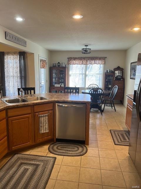 kitchen with light tile patterned flooring, appliances with stainless steel finishes, and sink