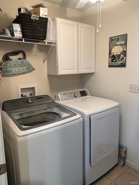 clothes washing area featuring light tile patterned flooring, cabinets, ceiling fan, and washer and dryer