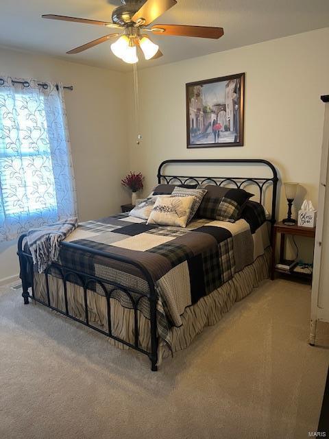 bedroom with light carpet and ceiling fan