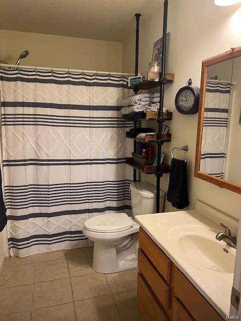 bathroom featuring vanity, a shower with shower curtain, tile patterned floors, and toilet