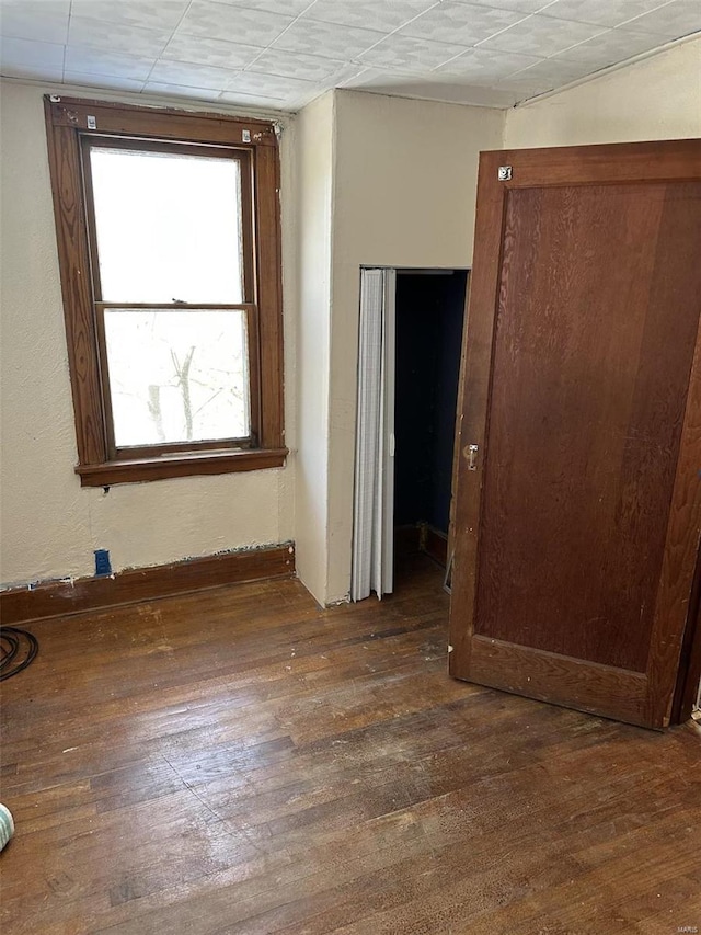 spare room featuring dark wood-type flooring