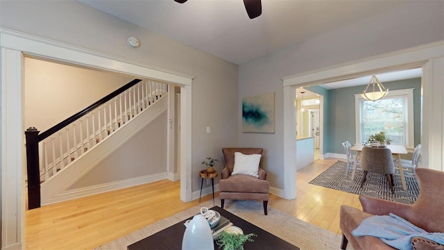 living area with hardwood / wood-style flooring and ceiling fan