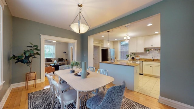 dining area with light hardwood / wood-style flooring and sink