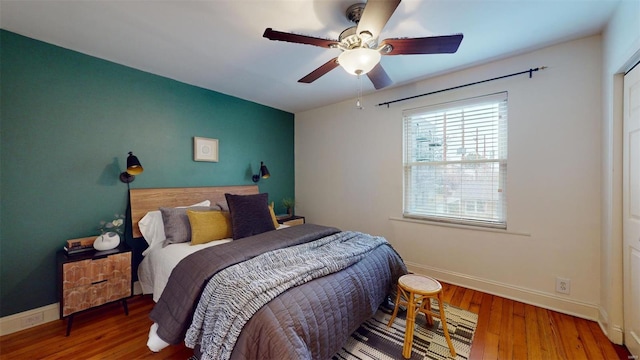 bedroom with ceiling fan and wood-type flooring